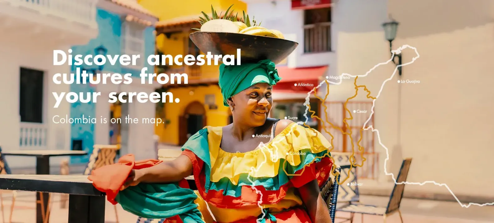 Woman wearing traditional dress and carrying fruit on her head on a street on the Caribbean coast