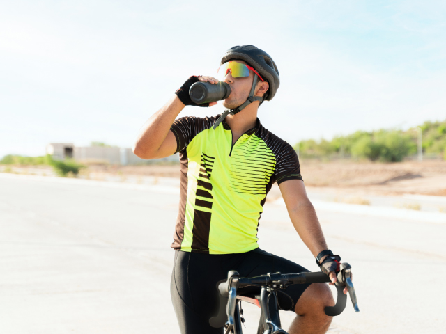 Cyclists wearing sportswear (cycling clothing such as cycling helmet).